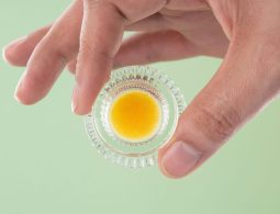 a person holding a small glass object in their hand