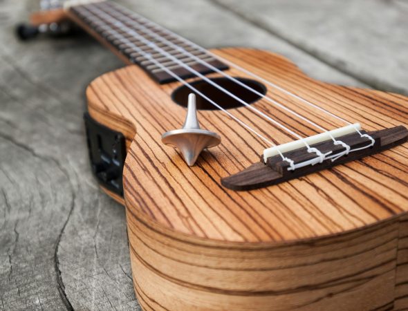 brown acoustic guitar on brown wooden table